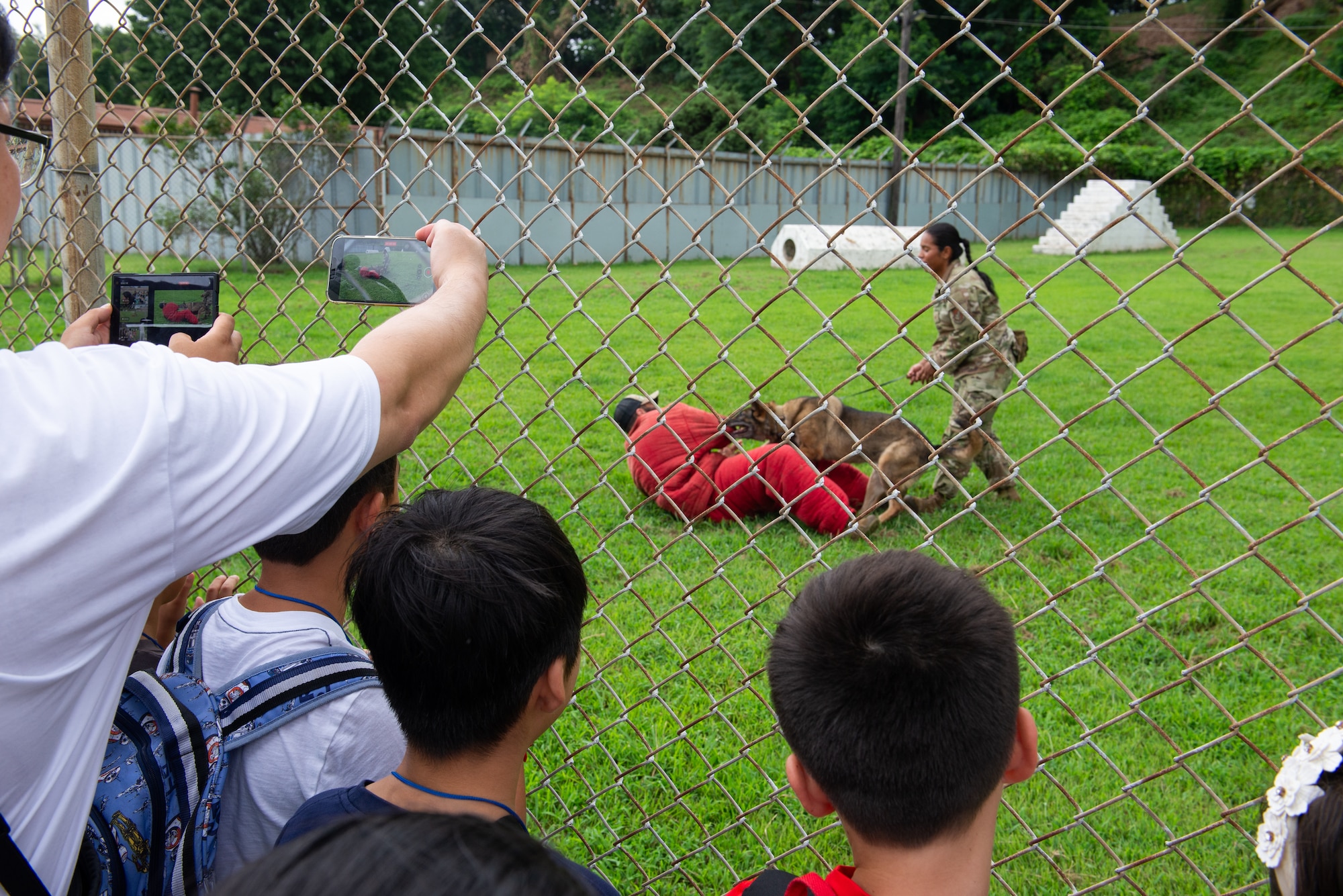 Airmen demonstrate how military working dogs apprehend subjects.