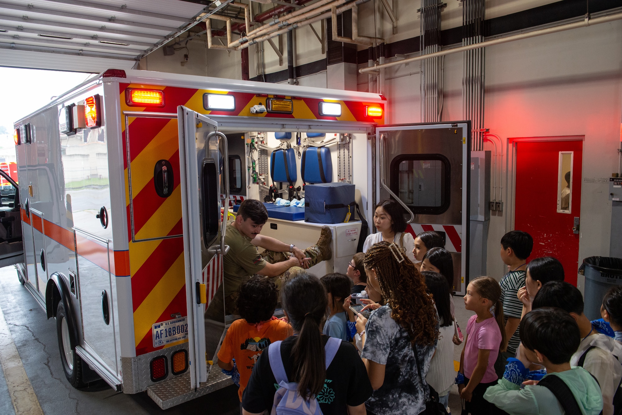 A fire fighter shows students the inside of an ambulance.