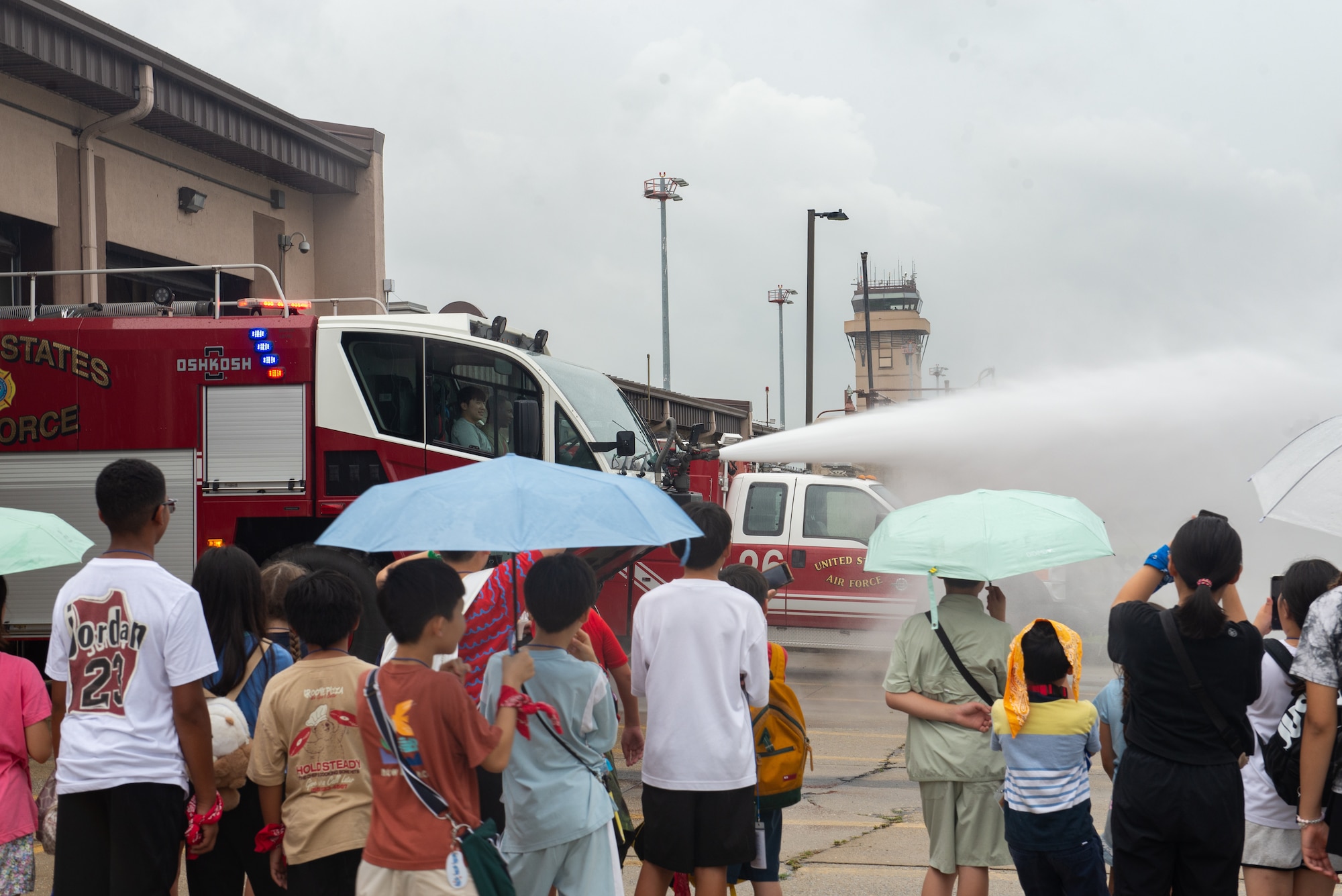Students watch a fire truck demonstration.