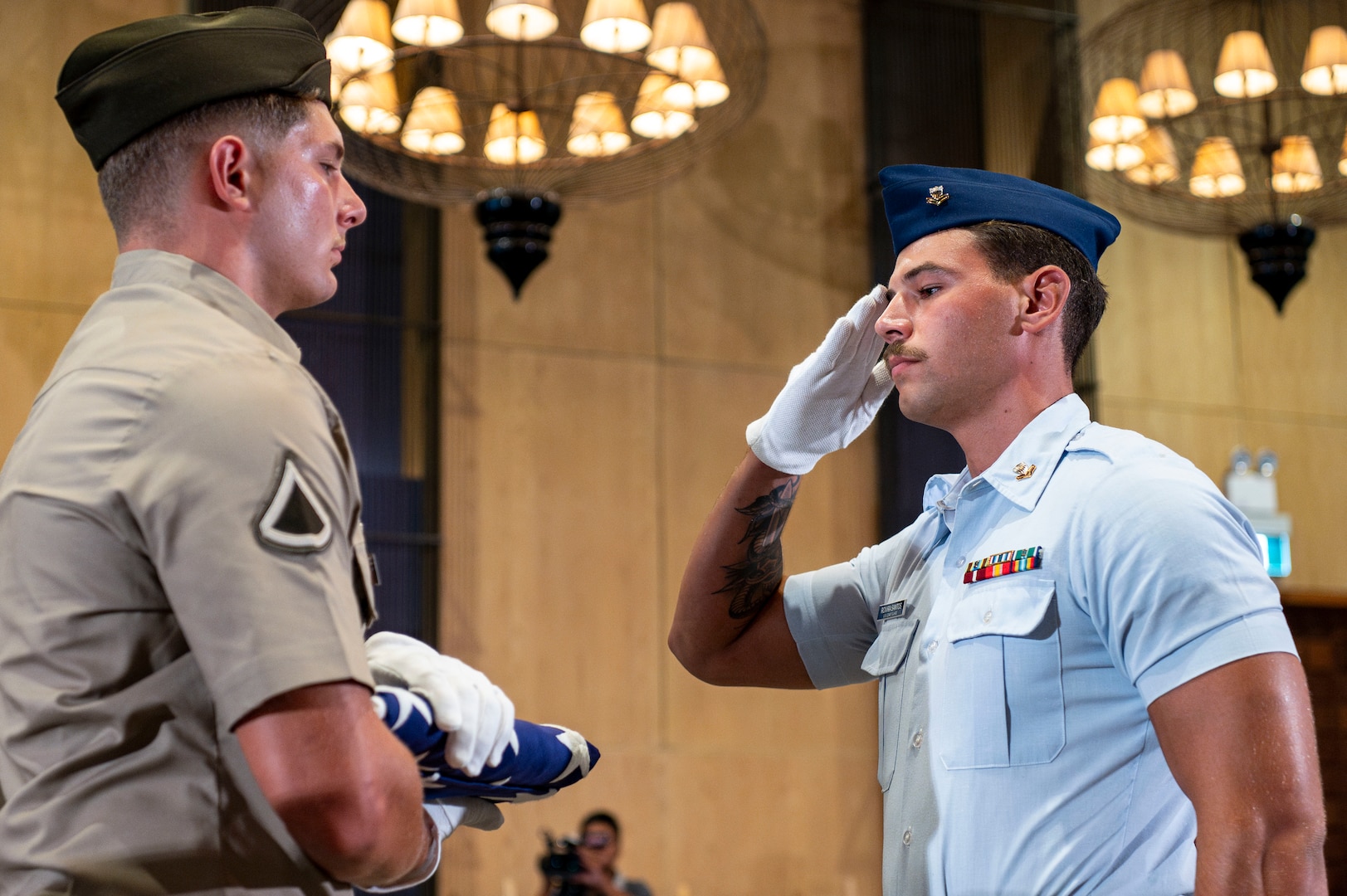 U.S. Coast Guard Petty Officer 2nd Class Gabriel Rovira Santos, right, a diver assigned to Regional Dive Locker East, salute the American flag held by U.S. Army Pfc. Shane Scott, a diver assigned to 7th Engineer Dive Detachment, during a repatriation ceremony in Da Nang Province, Vietnam, July 25, 2025.