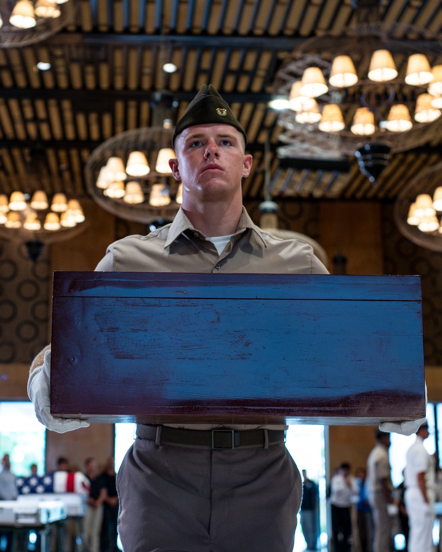 U.S. Army Spc. David Nash, a diver assigned to 7th Engineer Dive Detachment, carrier potential remains during a repatriation ceremony in Da Nang Province, Vietnam, July 25, 2025.