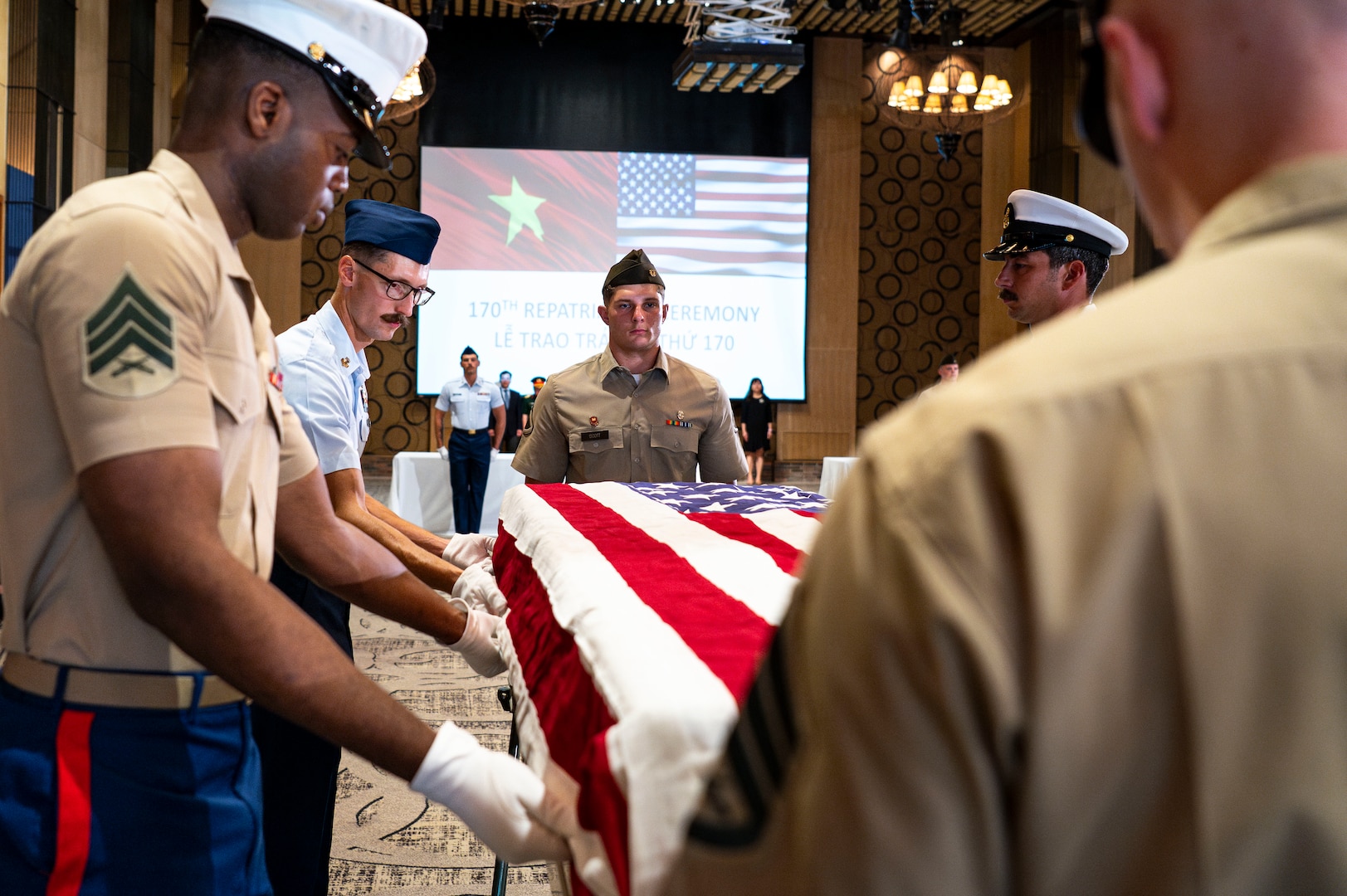 Members of 25-3VN Underwater Recovery Team for the Defense POW/MIA Accounting Agency, Vietnam Detachment 2, and U.S. Embassy Hanoi secures the American flag to a casket holding potential remains during a repatriation ceremony in Da Nang Province, Vietnam, July 25, 2025.