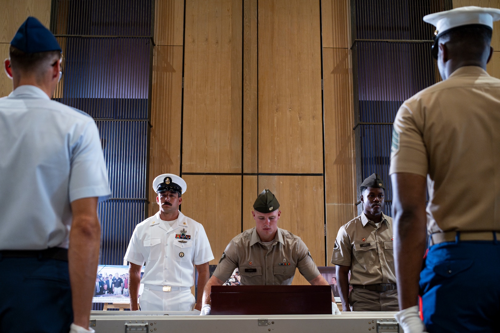 U.S. Army Spc. David Nash, center, a diver assigned to 7th Engineer Dive Detachment, places potential remains in a casket during a repatriation ceremony in Da Nang Province, Vietnam, July 25, 2025.