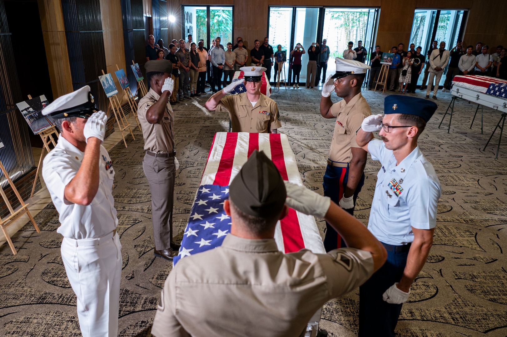 Members of 25-3VN Underwater Recovery Team for the Defense POW/MIA Accounting Agency and U.S. Embassy Hanoi salute a casket holding potential remains during a repatriation ceremony in Da Nang Province, Vietnam, July 25, 2025.
