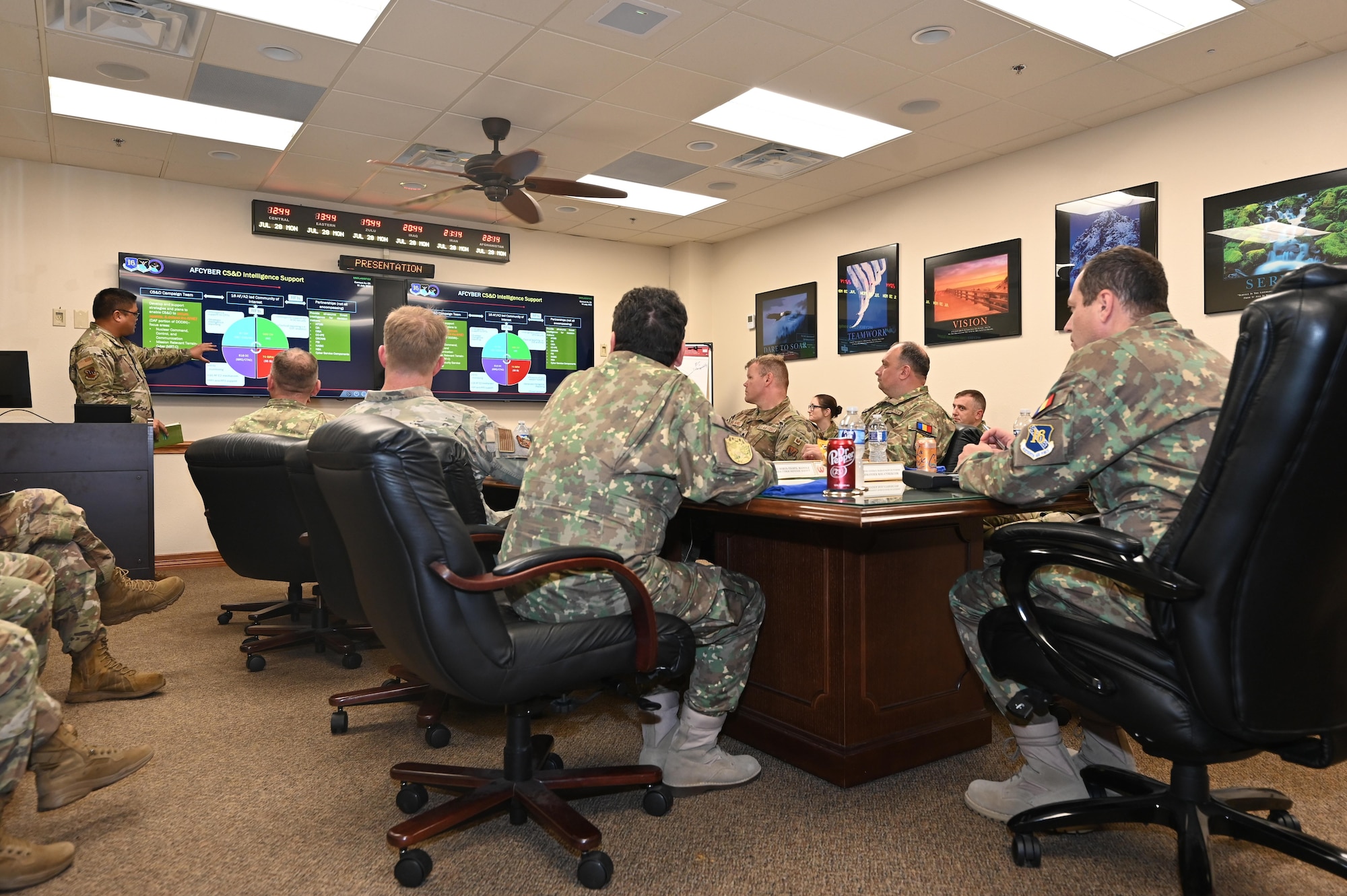 Leadership sits at table to discuss cyber partnership.