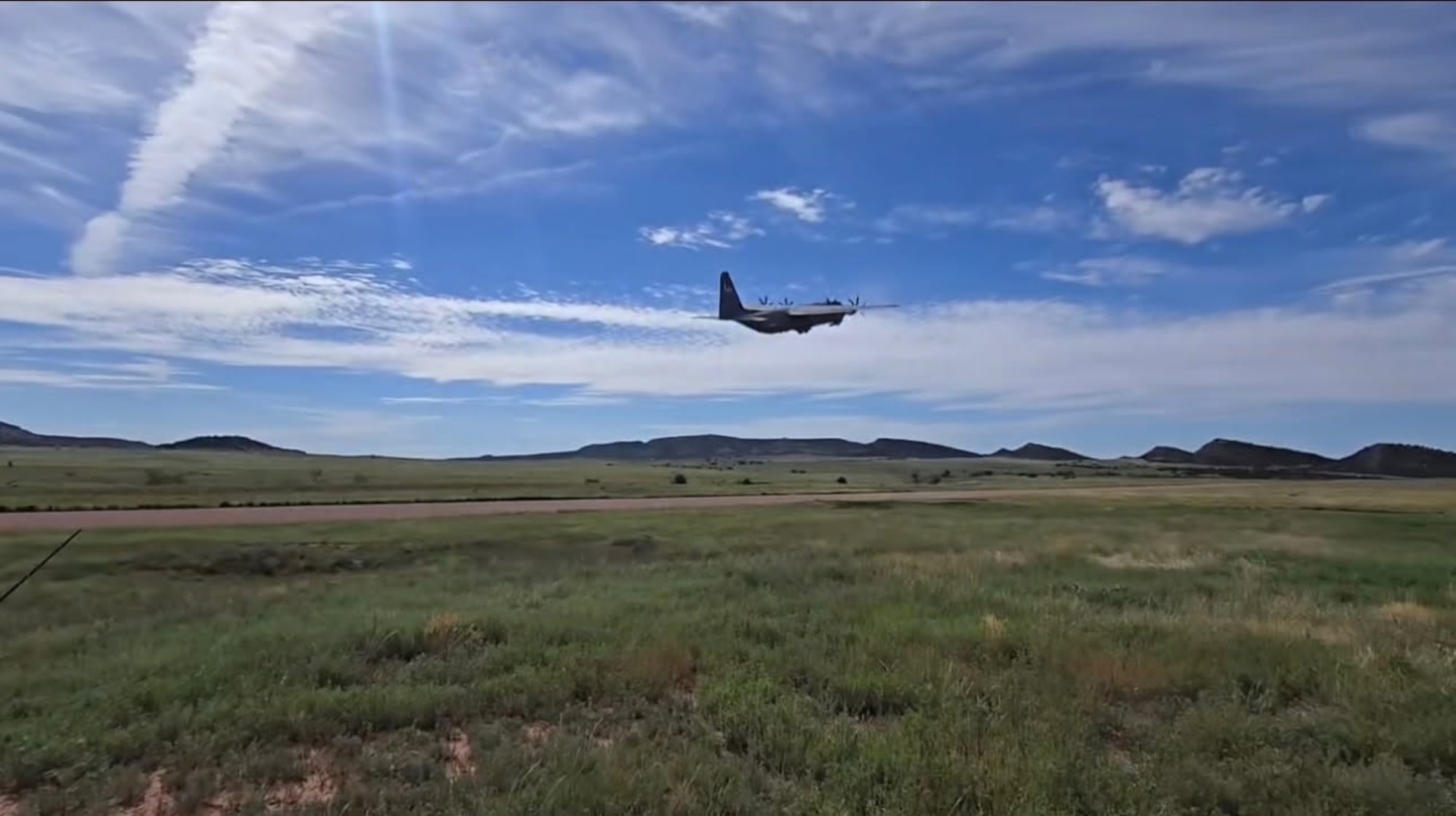 A military aircraft takes off into the sky.