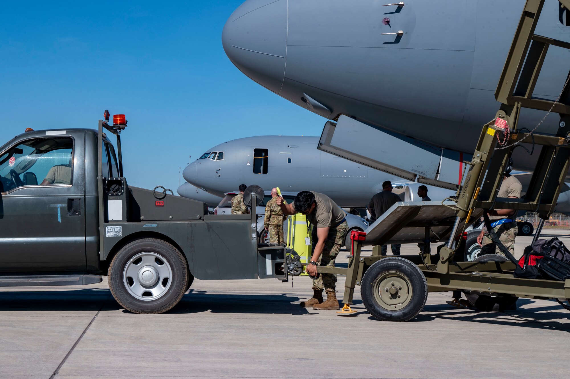 U.S. Air Force Staff Sgt. Brian Izaguirre, a crew chief with the 305th Aircraft Maintenance Squadron, Joint Base McGuire-Dix-Lakehurst, New Jersey, attaches maintenance stairs to a tow truck during Talisman Sabre 25 in Northern Territory, Australia, July 14, 2025. This training ensures that Air Mobility Command can respond rapidly and effectively to common challenges in dynamic situations. Talisman Sabre is the largest bilateral military exercise between Australia and the United States, that advances a safe and secure Indo-Pacific by strengthening relationships and interoperability among key allies and partners, while enhancing collective capabilities to respond to a wide array of potential security concerns. (U.S. Air Force photo by Senior Airman Clare Werner)