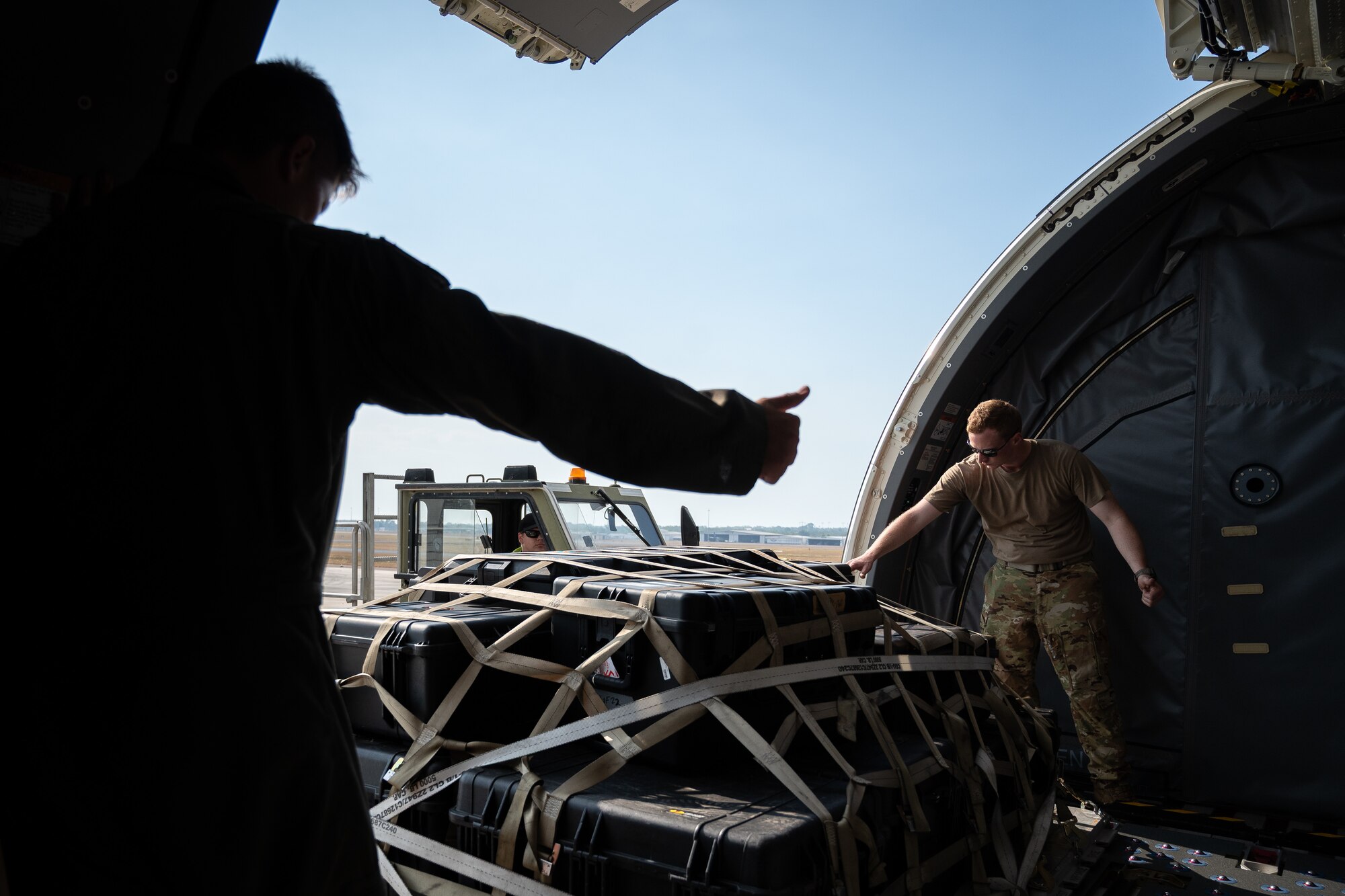U.S. Air Force Tech. Sgt. David Simpler, right, and Master Sgt. Andrew Abney, boom operators with the 2nd Air Refueling Squadron, move equipment off a K-Loader onto a KC-46 Pegasus aircraft during Talisman Sabre 25 in Northern Territory, Australia, July 25, 2025. Talisman Sabre is the largest bilateral military exercise between Australia and the United States, advancing a safe and secure Indo-Pacific by strengthening relationships and interoperability among key Allies and partners, while enhancing collective capabilities to respond to a wide array of potential security concerns. (U.S. Air Force photo by Tech. Sgt. Philip Bryant)