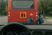 Safety starts with me – School buses in Germany don’t look like school buses in the U.S. The German school buses look like regular metro or city buses. There will be an orange sign on the back of the bus with an illustration of two children walking, though. That’s the differentiation. (Courtesy graphic)