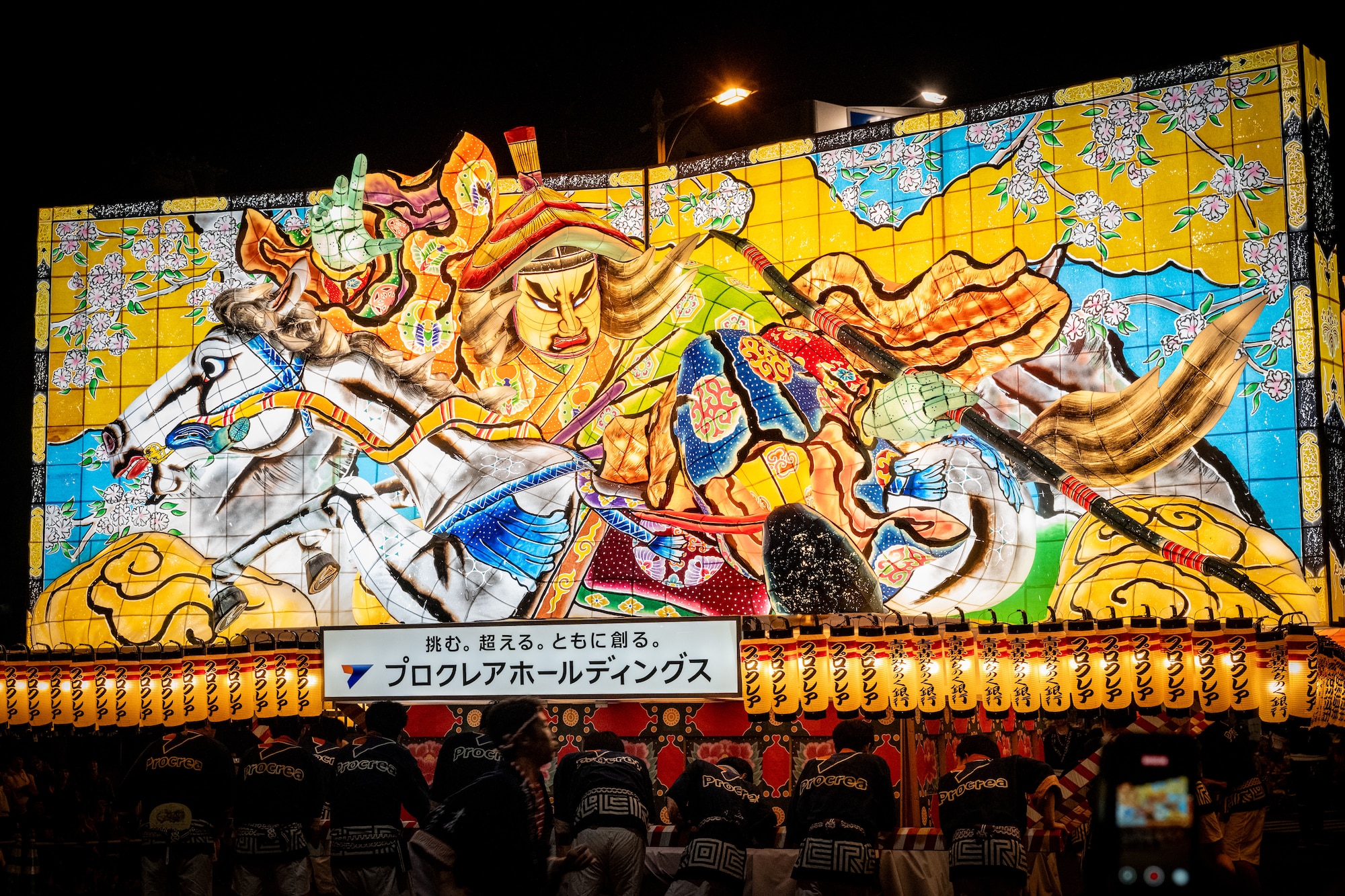 Festival participants push an illuminated parade float depicting historical, mythological and kabuki characters during the annual Nebuta Festival at Aomori City, Japan.