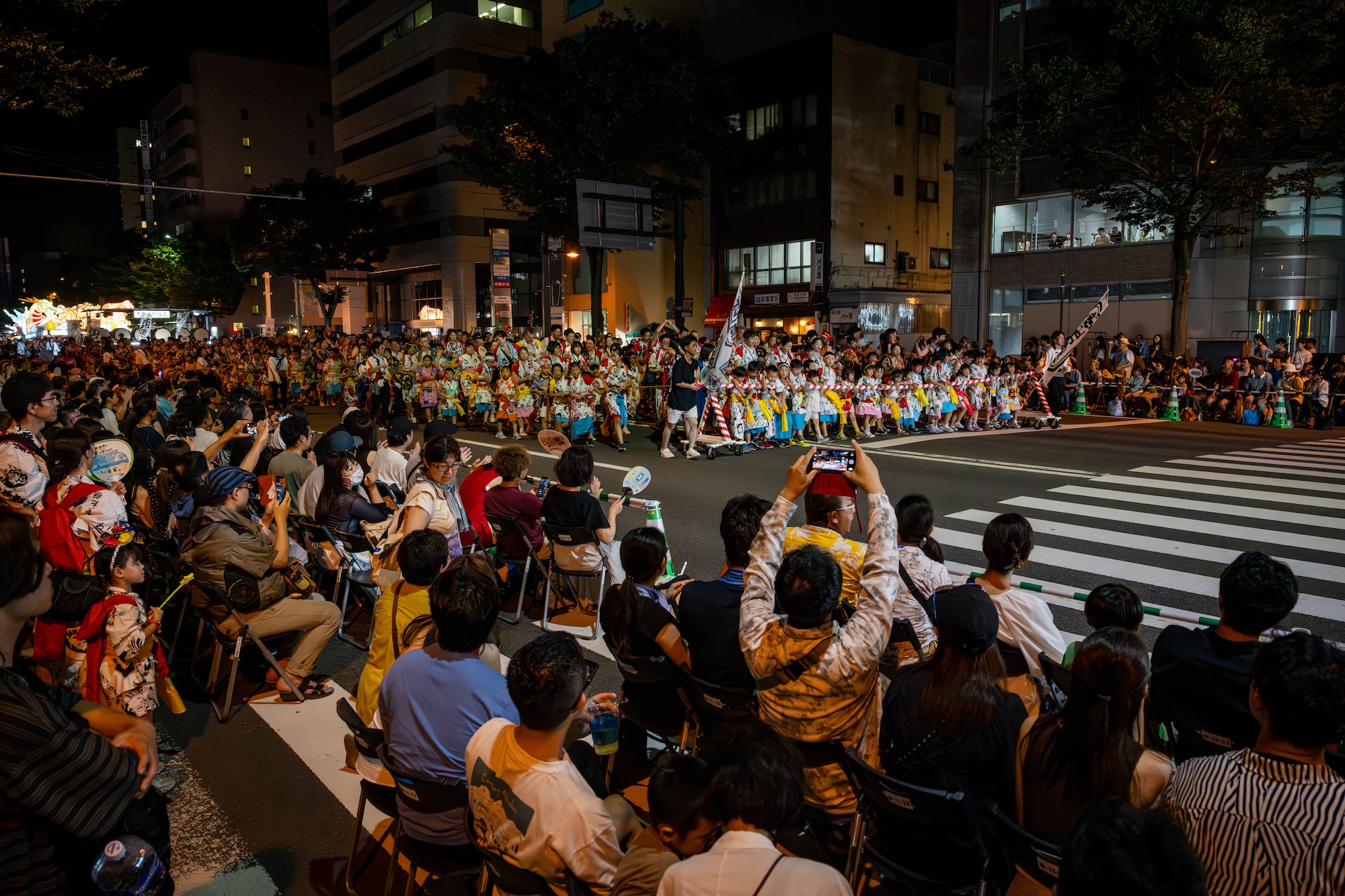 Haneto dancers and festival participants walk through the streets during the annual Nebuta Festival at Aomori City, Japan.