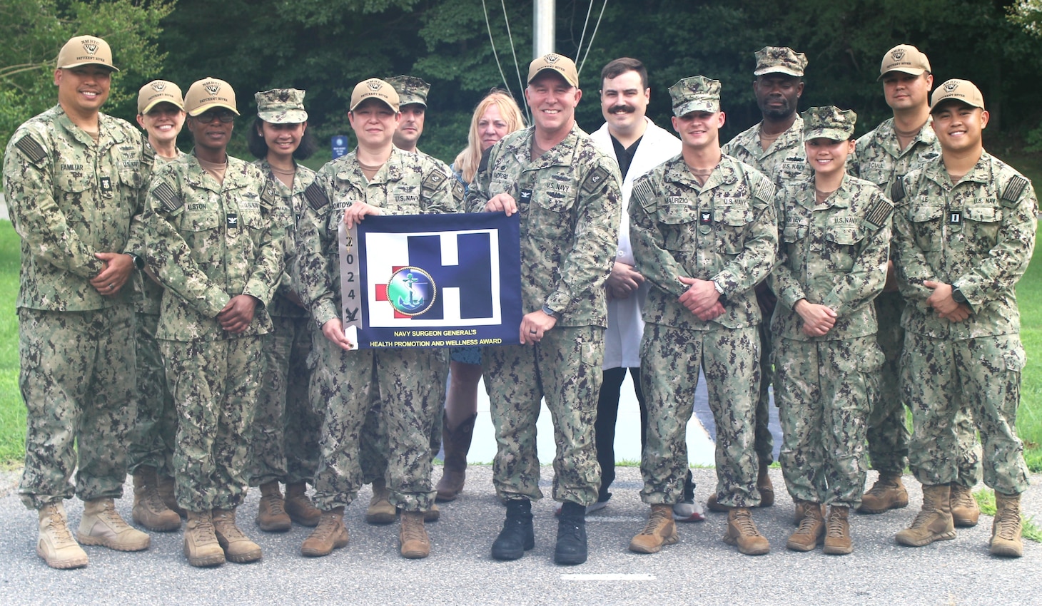 Navy Medicine Readiness and Training Command (NMRTC) Patuxent River leadership and staff celebrate the Silver Eagle "Blue H" award for 2024. Four local Naval Medical Commands have earned prestigious recognition for their outstanding contributions to health promotion and wellness. NMRTC Patuxent River oversees Naval Medical Readiness Training Unit (NMRTU) Dahlgren, NMRTC Detachment Indian Head, and NMRTC Detachment Joint Base Andrews (JBA).  All four commands have been recognized by the Navy Surgeon General, as receiving the Navy Surgeon General's Health Promotion and Wellness Award for 2024.