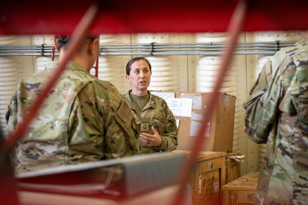 U.S. Air Force Airman speaks to two other Airman.