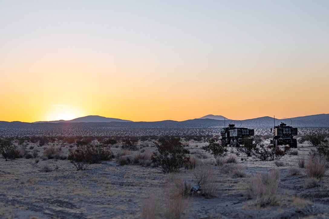 U.S. Marine Corps M142 High Mobility Artillery Rocket Systems with Echo Battery, 2d Battalion, 10th Marine Regiment, 2d Marine Division, stage during Service Level Training Exercise 4-25, on Marine Corps Air-Ground Combat Center, Twentynine Palms, California, Aug. 11, 2025. SLTE 4-25 is designed to be a challenging, realistic training environment that produces combat-ready forces capable of operating as an integrated Marine Air Ground Task Force across all domains of military operations. (U.S. Marine Corps photo by Lance Cpl. Judith Ann Lazaro)