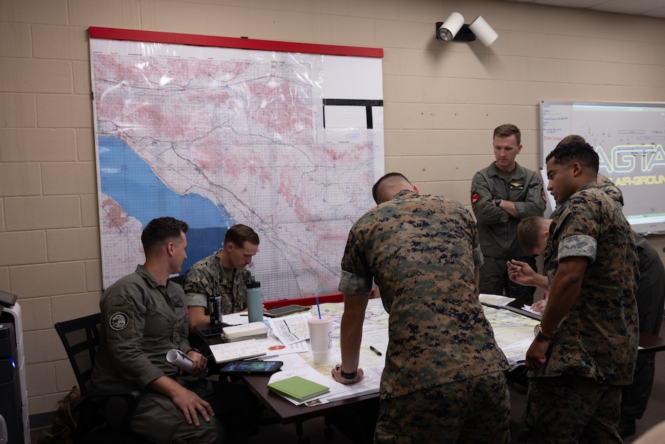 U.S. Marines plan a simulated air assault mission as part of Assault Support Planning Problem (ASPP) 1-26 at Marine Corps Air Station New River, North Carolina, Aug. 7, 2025. ASPP provides pilots with the opportunity to plan, brief and lead a company air assault mission prior to attending the Marine Corps’ Weapons and Tactics Instructor course. (U.S. Marine Corps photo by Cpl. Anakin Smith)