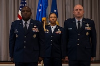 U.S. Air Force Lt. Col. Chad Polumbo, right, 2nd Intelligence Squadron incoming commander, stands alongside Col. Ryan L. O’Neal, left, 77th Intelligence Wing commander, as Senior Master Sgt. Alicia Smith, 2nd IS senior enlisted leader, carries the Air Force Provisional Flag in lieu of a guidon for Polumbo’s assumption of command ceremony at Joint Base Anacostia-Bolling, Washington, D.C., July 29, 2025.