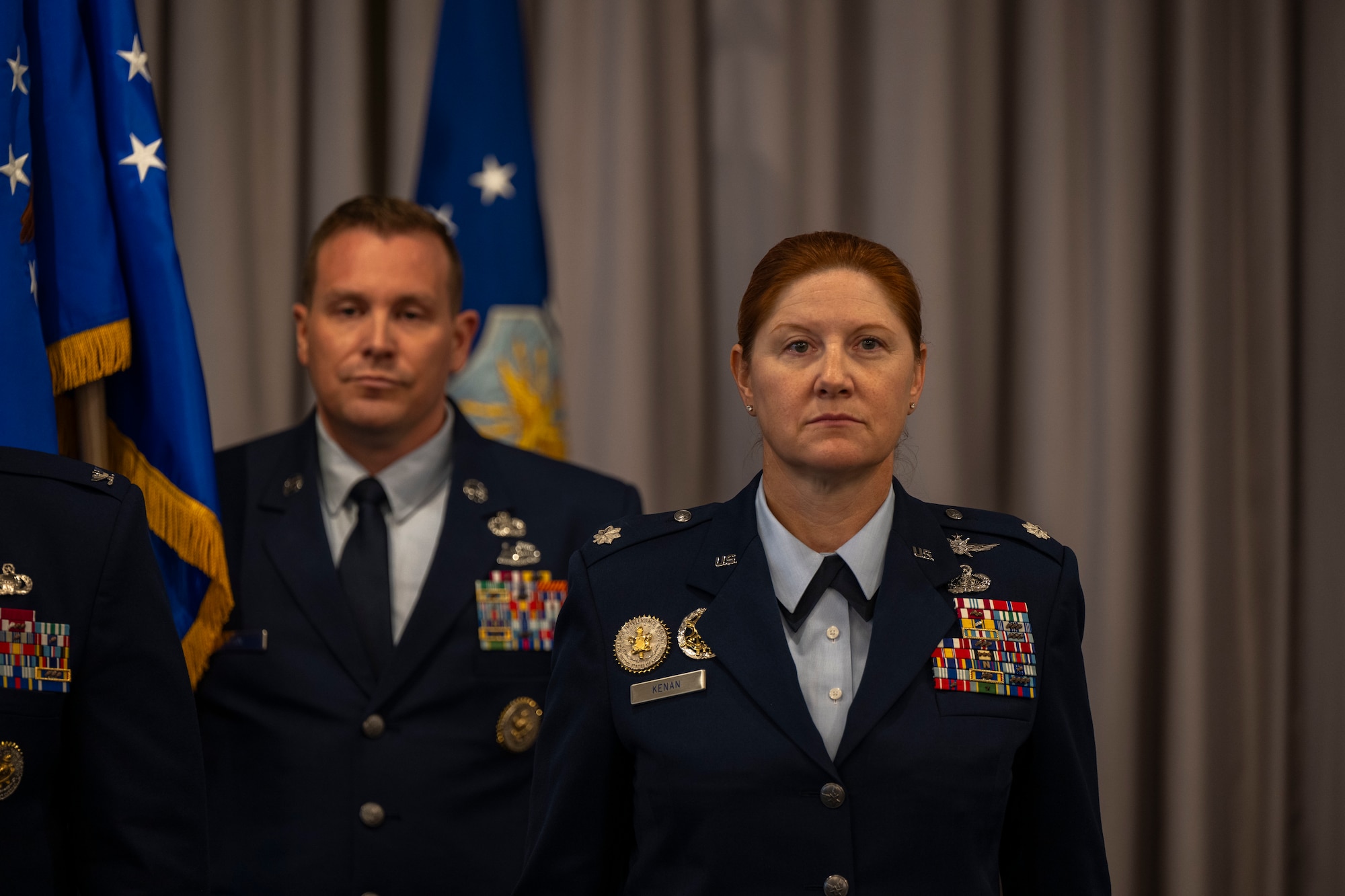U.S. Air Force Lt. Col. Kathryn Kenan, right, 5th Intelligence Support Squadron commander, stands at attention as Senior Master Sgt. Joshua Cain, 5th ISS senior enlisted leader, carries the Air Force Provisional Flag in lieu of a guidon for Kenan’s assumption of command ceremony at Joint Base Anacostia-Bolling, July 29, 2025.