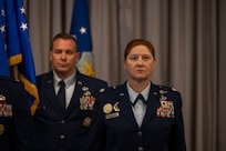 U.S. Air Force Lt. Col. Kathryn Kenan, right, 5th Intelligence Support Squadron commander, stands at attention as Senior Master Sgt. Joshua Cain, 5th ISS senior enlisted leader, carries the Air Force Provisional Flag in lieu of a guidon for Kenan’s assumption of command ceremony at Joint Base Anacostia-Bolling, July 29, 2025.