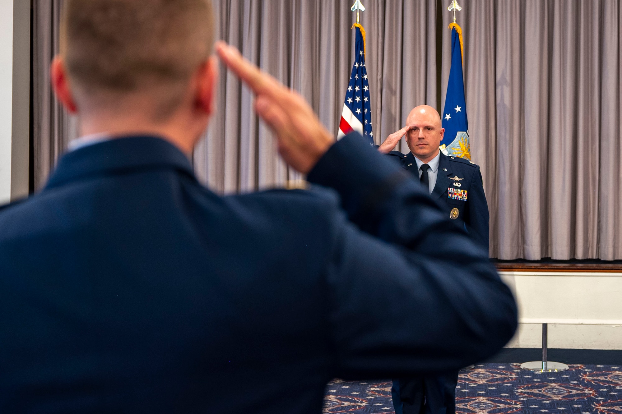 U.S. Air Force Lt. Col. Chad Polumbo, commander of the 2nd Intelligence Squadron, receives his first salute from Maj. David Moore, 2nd Intelligence Squadron Director of Operations, during an assumption of command ceremony at Joint Base Anacostia-Bolling, July 29, 2025.
