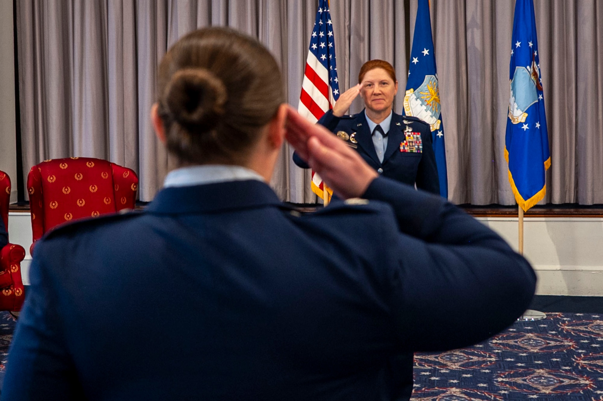 U.S. Air Force Lt. Col. Kathryn Kenan, commander of the 5th Intelligence Support Squadron receives her first salute from Lt. Col. Sarah Peterson, 5th ISS Director of Operations, during an assumption of command ceremony at Joint Base Anacostia-Bolling, July 29, 2025.