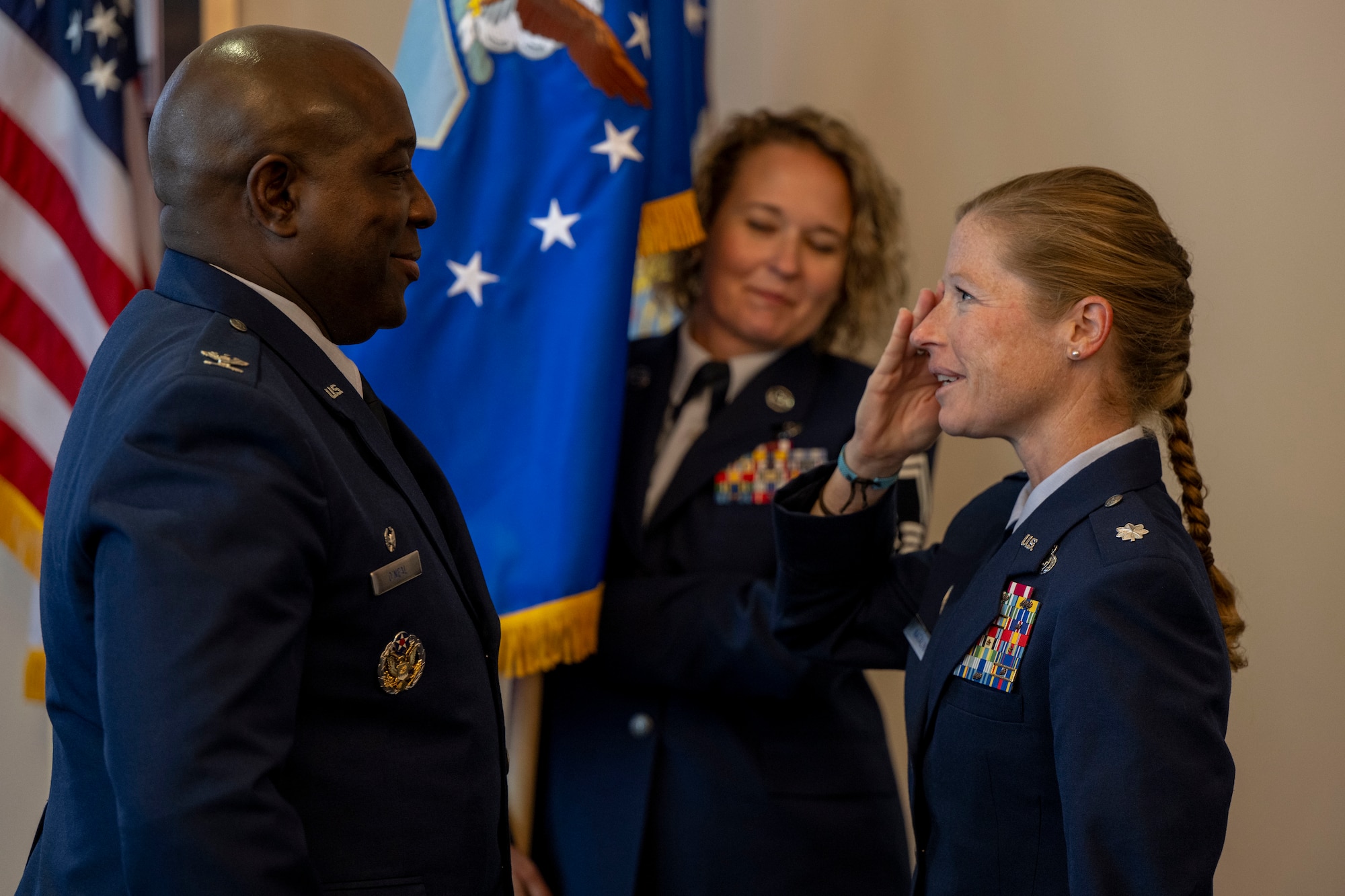 U.S. Air Force Lt. Col. Amy Natalani, right, commander of the 15th Intelligence Squadron, salutes Col. Ryan L. O’Neal, left, 77th Intelligence Wing commander, while Senior Master Sgt. Carley Blackwell, center, 15th Intelligence Squadron senior enlisted leader, holds the U.S. Air Force Flag during a dual assumption of command ceremony at Joint Base Anacostia-Bolling, Aug. 8, 2025.