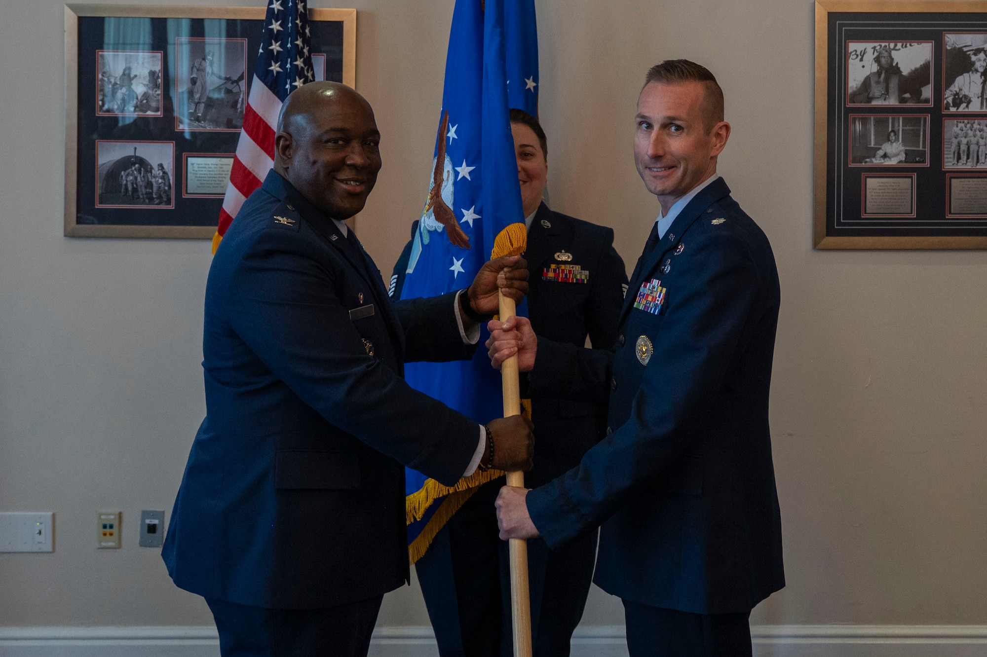 U.S. Air Force Col. Ryan L. O’Neal, left, 77th Intelligence Wing commander, transfers command of the 15th Intelligence Squadron to Lt. Col. Amy Natalani, right, while Senior Master Sgt. Carley Blackwell, center, 15th IS senior enlisted leader, stands at attention during a dual assumption of command ceremony at Joint Base Anacostia-Bolling, Aug. 8, 2025.