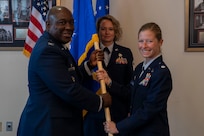 U.S. Air Force Col. Ryan L. O’Neal, left, 77th Intelligence Wing commander, transfers command of the 6th Intelligence Support Squadron to Lt. Col. Joseph Mellone, right, while Tech. Sgt. Kelsey Orvin, center, 6th ISS first sergeant, stands at attention during a dual assumption of command ceremony at Joint Base Anacostia-Bolling, Aug. 8, 2025.