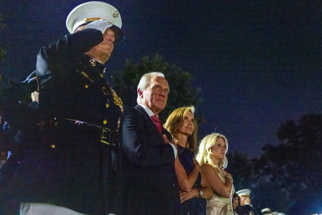 U.S. Marine Corps Lt. Gen. Leonard F. Anderson IV, commander of Marine Forces Reserve and Marine Forces South, and Mr. Greg Norman, Chief Executive Officer, Chairman and founder of the Greg Norman Company, renders salutes and honors alongside their spouses during the Friday Evening Parade at Marine Barracks Washington, D.C., Aug. 8, 2025. Norman was the guest of honor for the Evening Parade. (U.S. Marine Corps photo by Sgt. Samuel Qin)