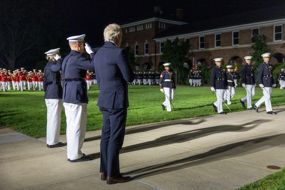 U.S. Marine Corps Lt. Gen. Leonard F. Anderson IV, commander of Marine Forces Reserve and Marine Forces South, Col. Carrie Batson, commanding officer, Marine Barracks Washington, and Mr. Greg Norman, Chief Executive Officer, Chairman and founder of the Greg Norman Company, renders salutes and honors during the Friday Evening Parade at Marine Barracks Washington, D.C., Aug. 8, 2025. Norman was the guest of honor for the Evening Parade. (U.S. Marine Corps photo by Sgt. Samuel Qin)
