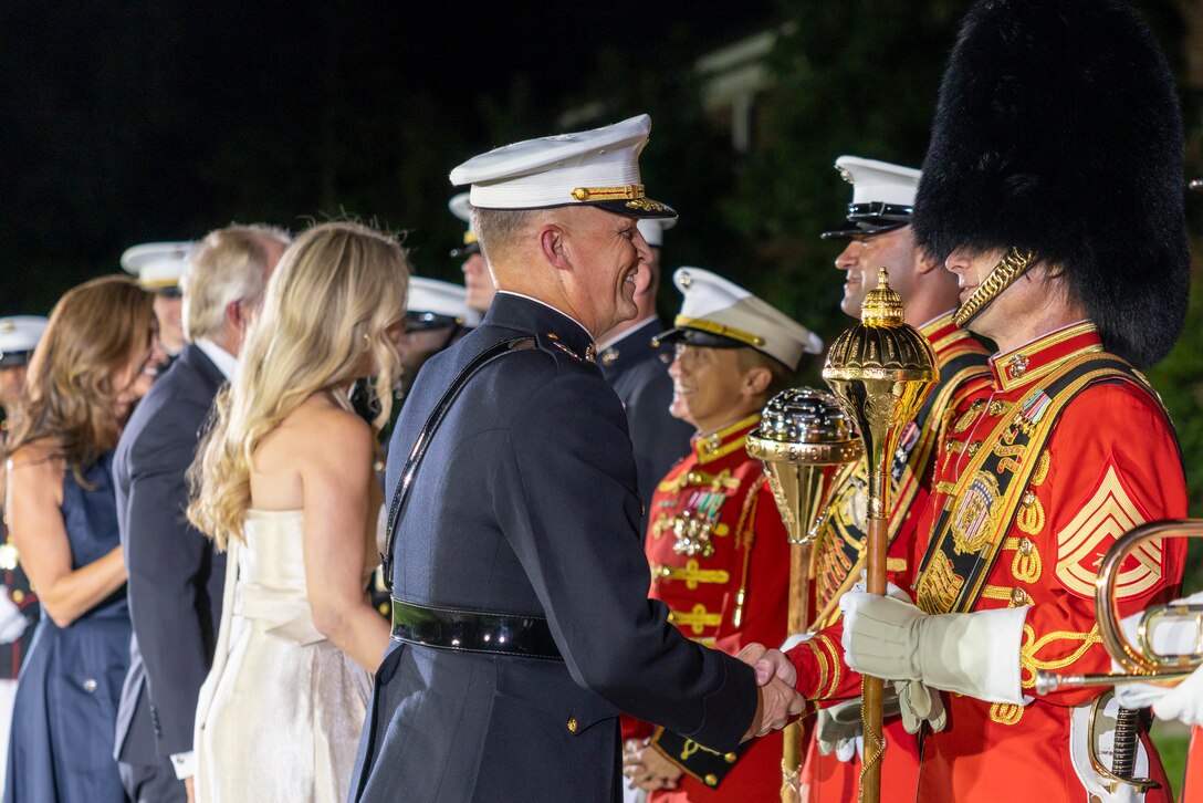 U.S. Marine Corps Lt. Gen. Leonard F. Anderson IV, commander of Marine Forces Reserve and Marine Forces South, thanks members of the "The Commandant's Own" U.S. Marine Corps Drum & Bugle Corps after a performance at the Friday Evening Parade at Marine Barracks Washington, D.C., Aug. 8, 2025. The Friday Evening Parade is a symbol of tradition and heritage of the Marine Corps. This parade, hosted by Anderson was held in honor of Mr. Greg Norman, Chief Executive Officer, Chairman and founder, Greg Norman Company. (U.S. Marine Corps photo by Sgt. Samuel Qin)