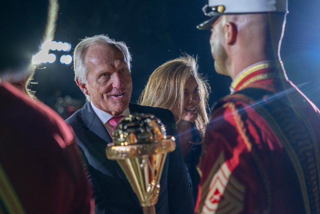 Mr. Greg Norman, Chief Executive Officer, Chairman and founder of the Greg Norman Company, thanks members of the "The Commandant's Own" U.S. Marine Corps Drum & Bugle Corps after a performance at the Friday Evening Parade at Marine Barracks Washington, D.C., Aug. 8, 2025. The Friday Evening Parade is a symbol of tradition and heritage of the Marine Corps. This parade, hosted by U.S. Marine Corps Lt. Gen. Leonard F. Anderson IV, commander of Marine Forces Reserve and Marine Forces South, was held in honor of Norman. (U.S. Marine Corps photo by Sgt. Samuel Qin)