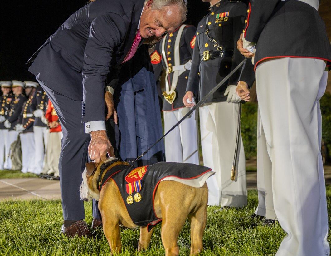 Mr. Greg Norman, Chief Executive Officer, Chairman and founder of the Greg Norman Company, thanks Cpl. Chesty XVI, the official mascot of Marine Barracks Washington,  after a performance at the Friday Evening Parade at Marine Barracks Washington, D.C., Aug. 8, 2025. The Friday Evening Parade is a symbol of tradition and heritage of the Marine Corps. This parade, hosted by U.S. Marine Corps Lt. Gen. Leonard F. Anderson IV, commander of Marine Forces Reserve and Marine Forces South, was held in honor of Norman. (U.S. Marine Corps photo by Sgt. Samuel Qin)