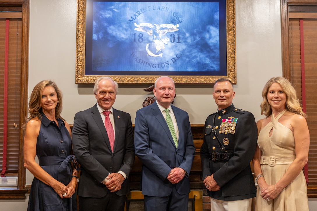 Retired U.S. Marine Corps Lt. Gen. James B. Laster, middle, Toys for Tots Foundation President & CEO, poses for a photo alongside U.S. Marine Corps Lt. Gen. Leonard F. Anderson IV, commander of Marine Forces Reserve and Marine Forces South, and Mr. Greg Norman, Chief Executive Officer, Chairman and founder of the Greg Norman Company, along with their spouses prior to a Friday Evening Parade at Marine Barracks Washington, D.C., Aug. 8, 2025. Norman was the guest of honor for the Evening Parade. (U.S. Marine Corps photo by Sgt. Samuel Qin)