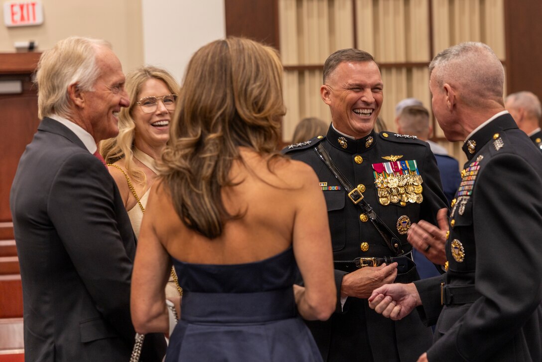 U.S. Marine Corps Lt. Gen. Leonard F. Anderson IV, middle right, commander of Marine Forces Reserve and Marine Forces South, and Mr. Greg Norman, left, Chief Executive Officer, Chairman and founder of the Greg Norman Company, along with their spouses speak with the 39th Commandant of the Marine Corps, Gen. Eric M. Smith, prior to a Friday Evening Parade at Marine Barracks Washington, D.C., Aug. 8, 2025. Norman was the guest of honor for the Evening Parade. (U.S. Marine Corps photo by Sgt. Samuel Qin)