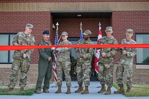 Members of Team Little Rock and the U.S. Army Corps of Engineers cut a ribbon to dedicate new dorms at Little Rock Air Force Base, Arkansas, Aug. 12, 2025. The dorms add 136 resident rooms, bringing the dorm campus capacity to a total of 586.