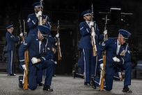 Members of the U.S. Air Force Honor Guard Drill Team kneel and stand during the kneeling bone crusher drill movement at the 75th Royal Edinburgh Military Tattoo in Edinburgh, Scotland, Aug. 1, 2025. Military bands and drill teams from the U.S., United Kingdom, Switzerland, Canada, Germany, Poland, and Ukraine performed during the 24-day event. (U.S. Air Force photo by Hayden Hallman)