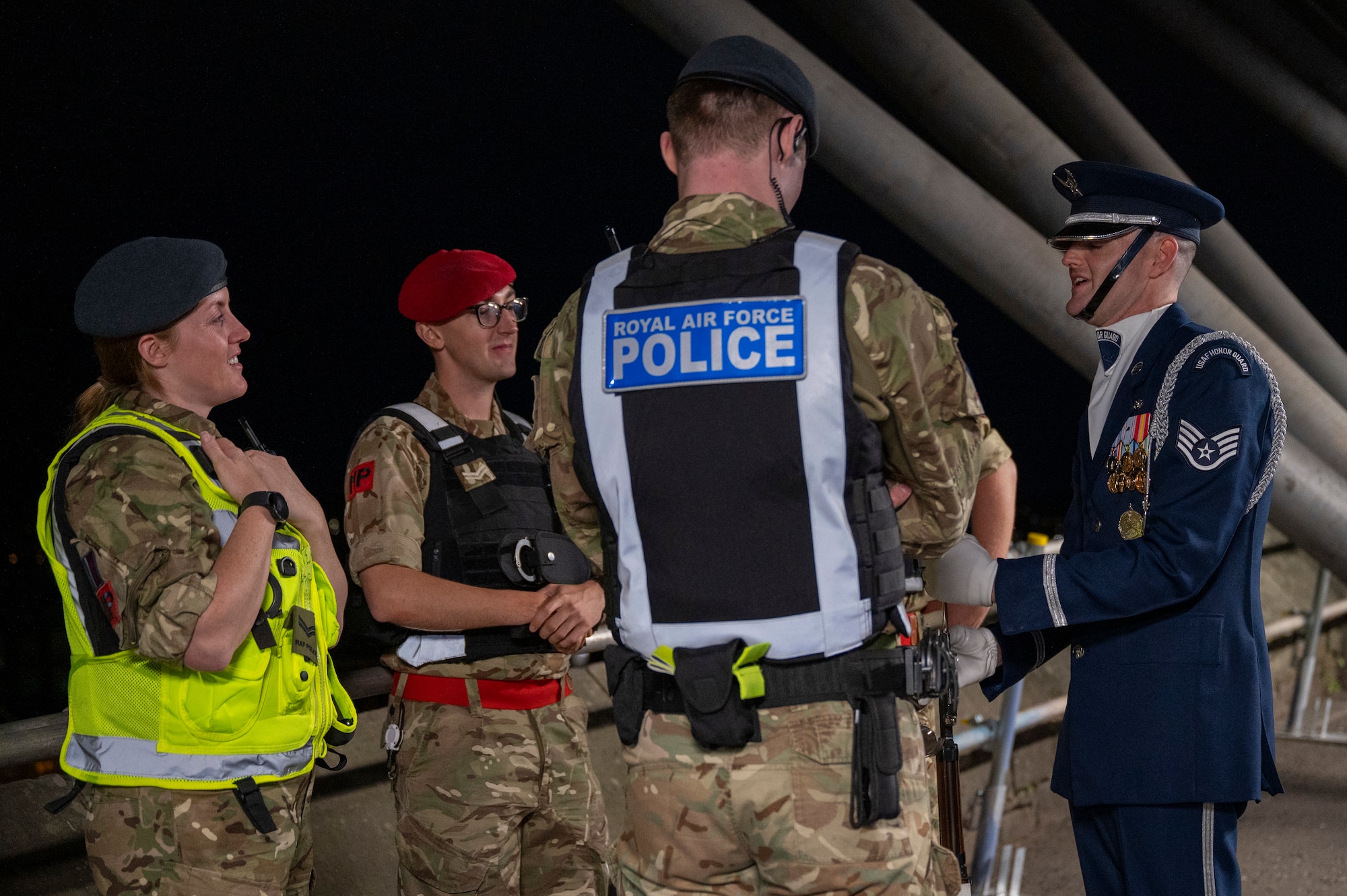 U.S. Air Force Staff Sgt. William Douglass, ceremonial guardsman with the U.S. Air Force Honor Guard Drill Team, speaks to members of the Royal Air Force and the British Army during the 75th Royal Edinburgh Military Tattoo in Edinburgh, Scotland, Aug. 1, 2025. The Drill Team strengthened partnerships between the U.S. Air Force and U.S. allies by emphasizing the camaraderie and mutual respect among partner nations. (U.S. Air Force photo by Hayden Hallman)