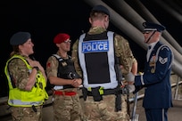 U.S. Air Force Staff Sgt. William Douglass, ceremonial guardsman with the U.S. Air Force Honor Guard Drill Team, speaks to members of the Royal Air Force and the British Army during the 75th Royal Edinburgh Military Tattoo in Edinburgh, Scotland, Aug. 1, 2025. The Drill Team strengthened partnerships between the U.S. Air Force and U.S. allies by emphasizing the camaraderie and mutual respect among partner nations. (U.S. Air Force photo by Hayden Hallman)