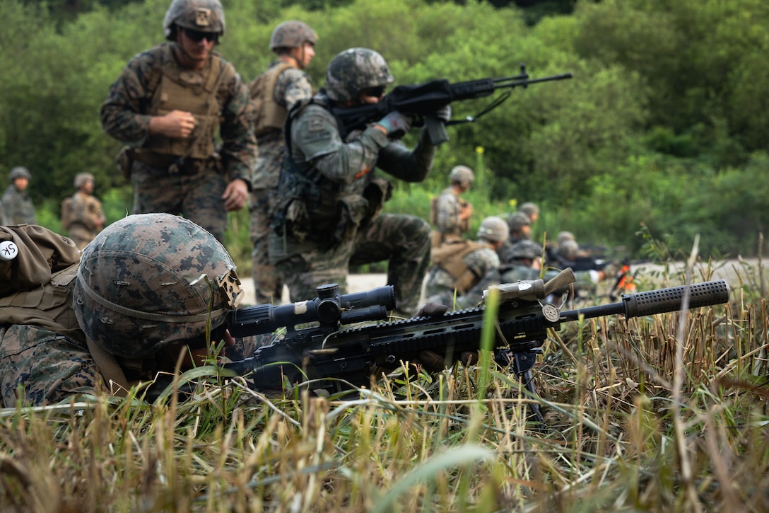 U.S. Marine Corps Lance Cpl. Samuel Kuhn, a rifleman with 2nd Battalion, 23rd Marines, forward deployed with 4th Marine Regiment, 3d Marine Division as part of the Unit Deployment Program, and Republic of Korea Marines fires at targets during a reaction to contact drill during the Korean Marine Exercise Program 25.2 in Pocheon, South Korea, July 29, 2025. KMEP is conducted regularly between the ROK and U.S. Marine Corps to increase their combined capabilities through realistic training geared towards deterrence and maintaining peace in the Indo-Pacific. (U.S. Marine Corps photo by Lance Cpl. Van Hoang)