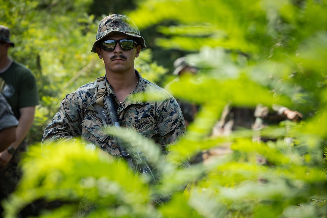 U.S. Marine Corps Lance Cpl. Nathan Christiansen, a machine gunner with 2nd Battalion, 23rd Marines, forward deployed with 4th Marine Regiment, 3rd Marine Division as part of the Unit Deployment Program, prepares to clear a room during military operations in urban terrain training during the Korean Marine Exchange Program 25.2 in Pocheon, South Korea, July 23, 2025. KMEP is conducted regularly between the ROK and U.S. Marine Corps to increase their combined capabilities through realistic training geared towards deterring threats and maintaining peace in the Indo-Pacific. (U.S. Marine Corps photo by Lance Cpl. Van Hoang)