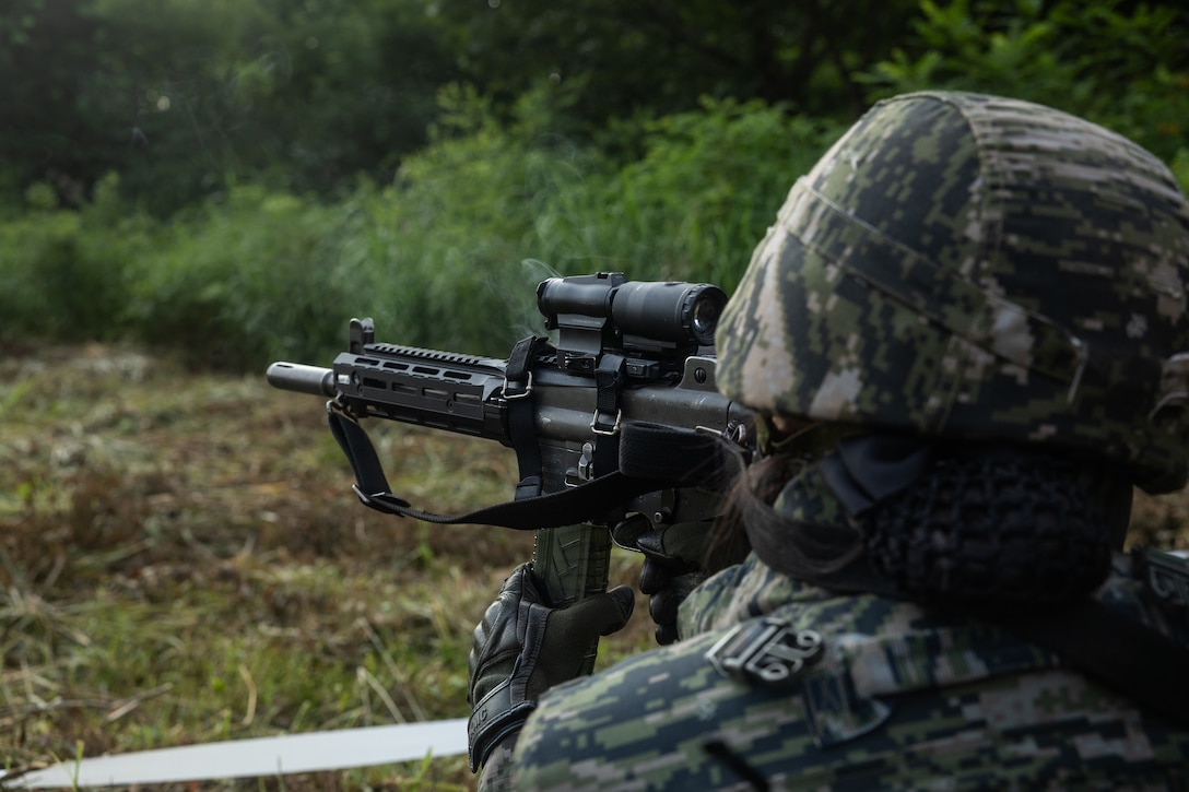 A Republic of Korea Marines reloads before firing at targets during a reaction to contact drill during the Korean Marine Exercise Program 25.2 in Pocheon, South Korea, July 29, 2025. KMEP is conducted regularly between the ROK and U.S. Marine Corps to increase their combined capabilities through realistic training geared towards deterrence and maintaining peace in the Indo-Pacific. (U.S. Marine Corps photo by Lance Cpl. Van Hoang)