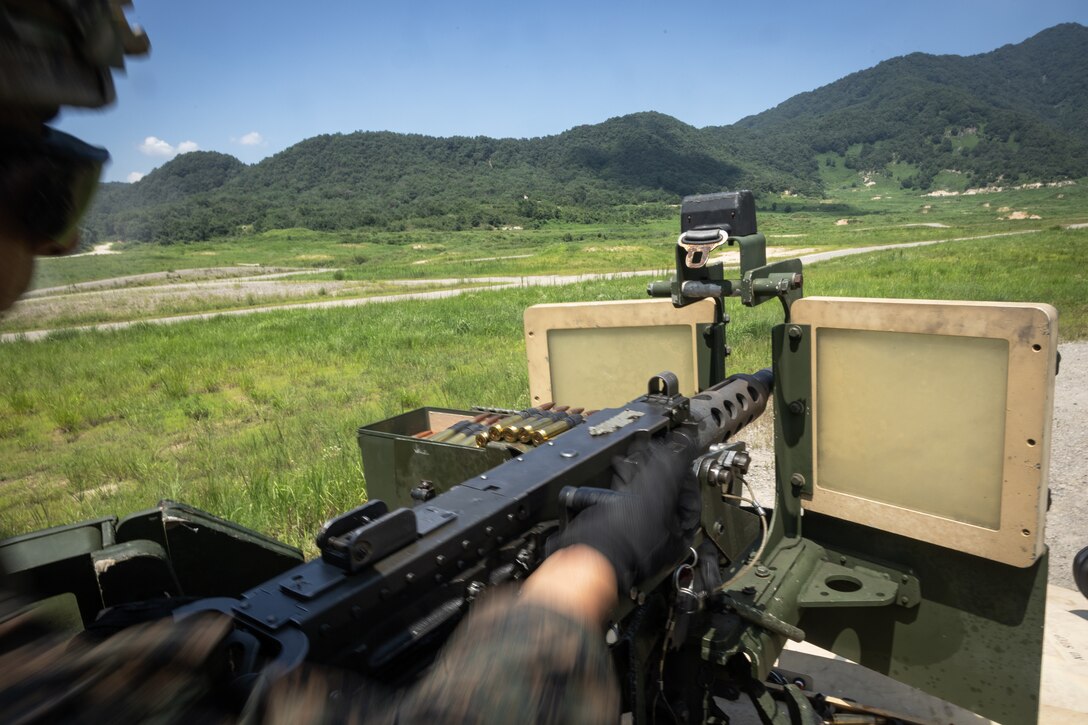 U.S. Marine Corps Lance Cpl. Fernando Esquivel, a machine gunner with 2nd Battalion, 23rd Marines, forward deployed with 4th Marine Regiment, 3d Marine Division as part of the Unit Deployment Program, racks the bolt of an M2 machine gun during the Korean Marine Exercise Program 25.2 in Pocheon, South Korea, July 29, 2025. KMEP is conducted regularly between the ROK and U.S. Marine Corps to increase their combined capabilities through realistic training geared towards deterrence and maintaining peace in the Indo-Pacific. (U.S. Marine Corps photo by Lance Cpl. Van Hoang)