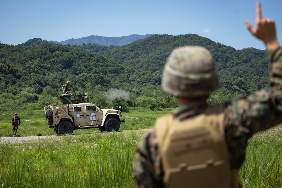 U.S. Marine Corps Cpl. Charles Dolen, right, a machine gunner with 2nd Battalion, 23rd Marines, forward deployed with 4th Marine Regiment, 3d Marine Division as part of the Unit Deployment Program, coordinates fires between multiple M2 .50 caliber machine guns during the Korean Marine Exercise Program 25.2 in Pocheon, South Korea, July 29, 2025. KMEP is conducted regularly between the ROK and U.S. Marine Corps to increase their combined capabilities through realistic training geared towards deterrence and maintaining peace in the Indo-Pacific. (U.S. Marine Corps photo by Lance Cpl. Van Hoang)