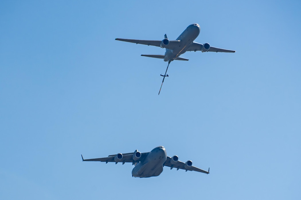 A U.S. Air Force C-17 Globemaster III and KC-46 Pegasus aircraft perform an aerial refueling demonstration pass in the skies over the Abbotsford International Airport, Canada, Aug. 10, 2025. This was the first time the C-17 and KC-46 performed a combined aerial refueling profile for an air show. (U.S. Air Force photo by Airman 1st Class Lauren Torres)