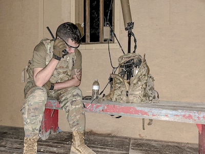 Spc. Robert Bowley, an electromagnetic warfare specialist with the 37th Infantry Brigade Combat Team, radios from his position while monitoring the electromagnetic spectrum with the Beast+ system during Northern Strike at Camp Grayling, Michigan, Aug. 12, 2025.