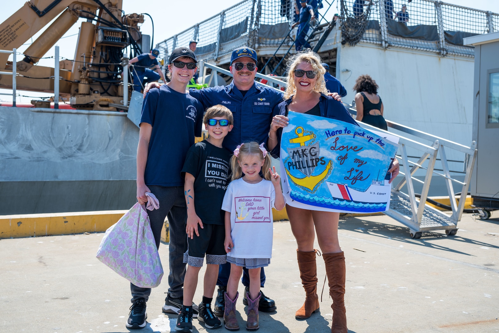 Chief Petty Officer Colin Phillips, a machinery technician aboard U.S. Coast Guard Cutter Bertholf (WMSL 750) reunites with his family at the pier during the ship's return to home port in Alameda, California Aug. 10, 2025. Bertholf deployed in support of Operation BORDER TRIDENT, Coast Guard Southwest District’s (CGD-SW) standing operation to counter-illicit maritime activity along the Southwest maritime border. (U.S. Coast Guard photo by Petty Officer 3rd Class Austin Wiley)