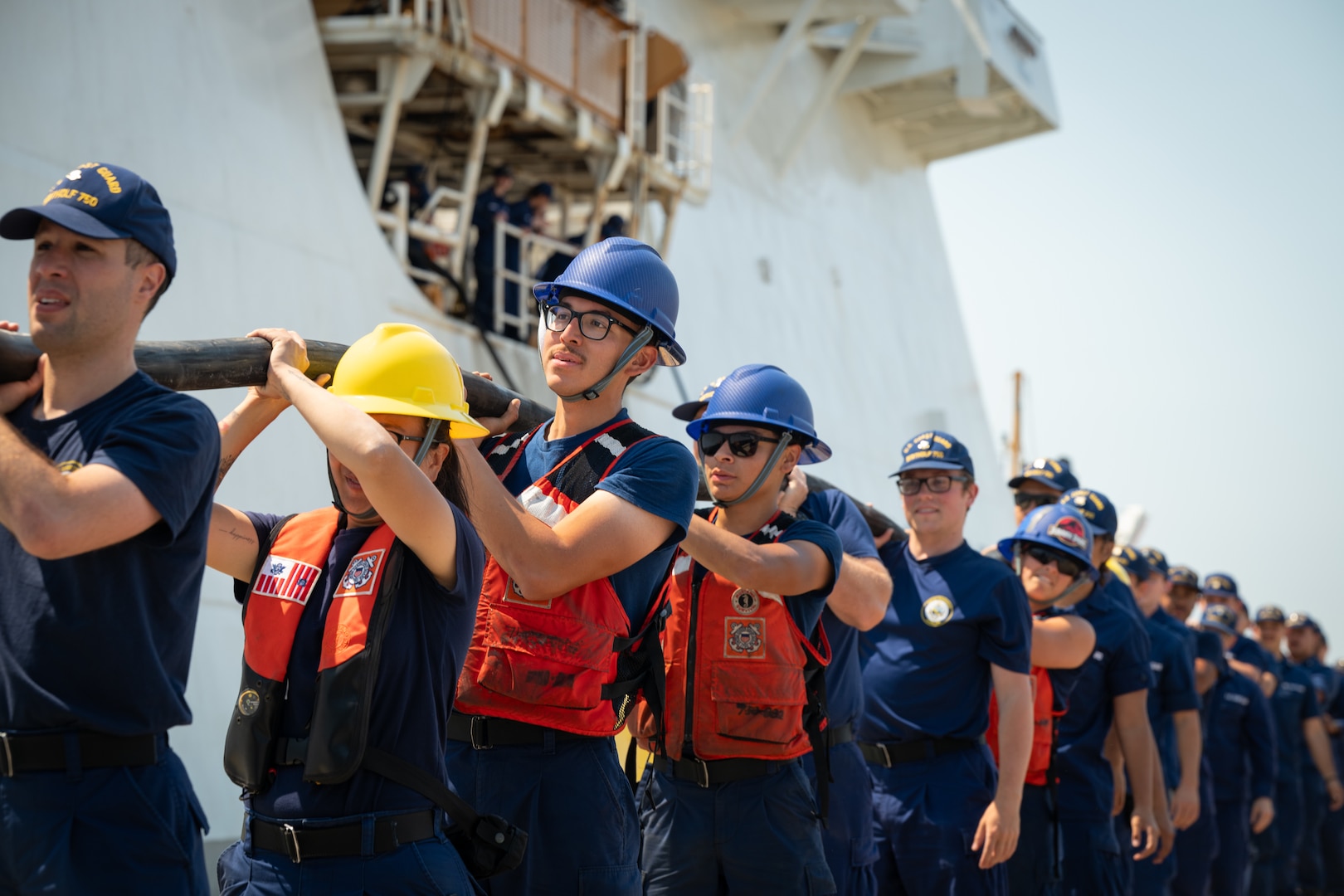 Crewmembers attached to the United States Coast Guard Cutter Bertholf (WMSL 750) hoist a power line in Alameda, California, Aug. 10, 2025. To maintain her shipboard helicopter operation proficiency, the Bertholf conducted 180 helicopter deck landings with Coast Guard Air Station (AIRSTA) San Diego and AIRSTA Ventura. (U.S. Coast Guard photo by Petty Officer 3rd Class Kenneth Wiese.)