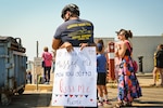 A crewmember attached to the United States Coast Guard Cutter Bertholf (WMSL 750) greets his significant other in Alameda, California, Aug. 10, 2025. The Bertholf participated in Operation BORDER TRIDENT - a Coast Guard-led interagency approach to detection, monitoring, interdiction, and apprehension operations to combat Transnational Criminal Organization and illegal migration activity in the California coastal region. (U.S. Coast Guard photo by Petty Officer 3rd Class Kenneth Wiese.)