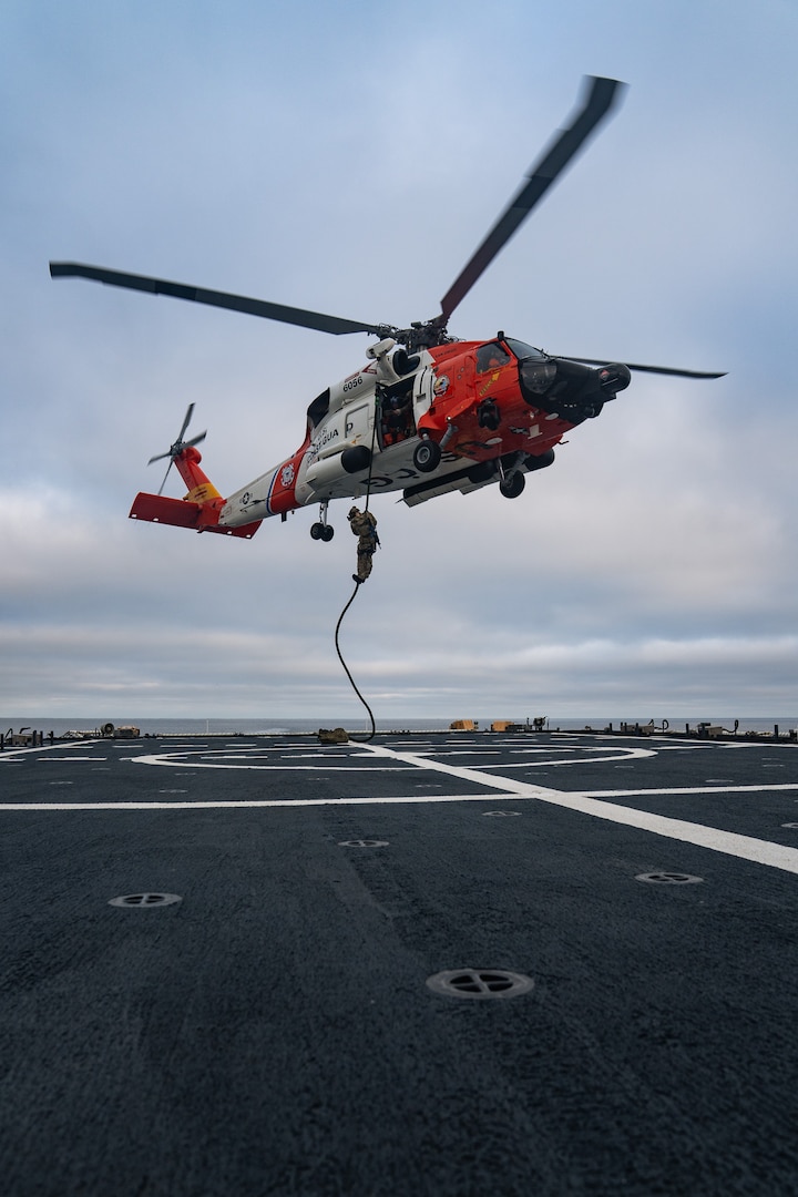 A member of U.S. Coast Guard Maritime Security Response Team West (MSRT-W) rappels from an MH-60 Jayhawk helicopter onto the flight deck of the U.S. Coast Guard Cutter Bertholf (WMSL 750) in the Pacific Ocean, June 26, 2025. MSRT units focus their efforts on law enforcement and maritime counterterrorism. (U.S. Coast Guard photo by Petty Officer 3rd Class Avery Tibbets)