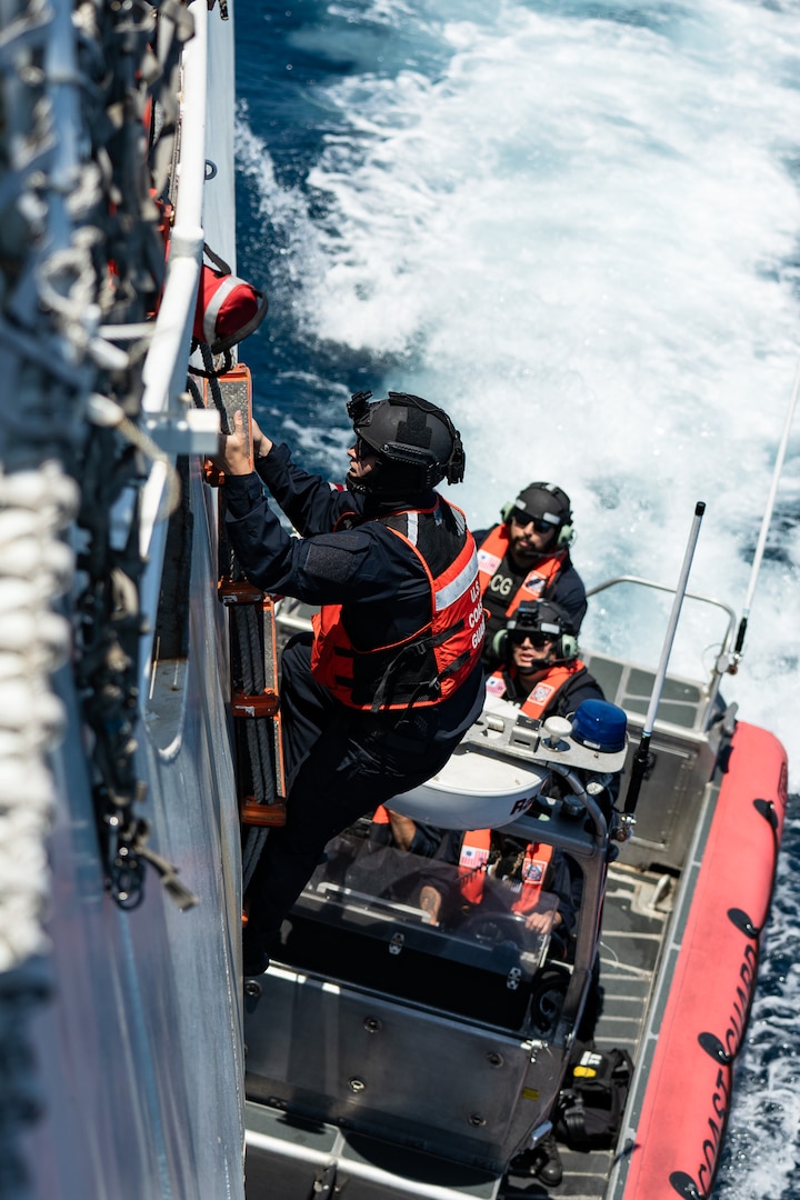 Petty Officer 3rd Class Carter Hand, a crew member aboard the U.S. Coast Guard Cutter Bertholf (WMSL 750) scales a Jacob’s Ladder on Bertholf’s hull in the Pacific Ocean, June 27, 2025. Maintaining the safety of crewmembers and boats are essential in close-quarters training. (U.S. Coast Guard photo by Petty Officer 3rd Class Avery Tibbets)